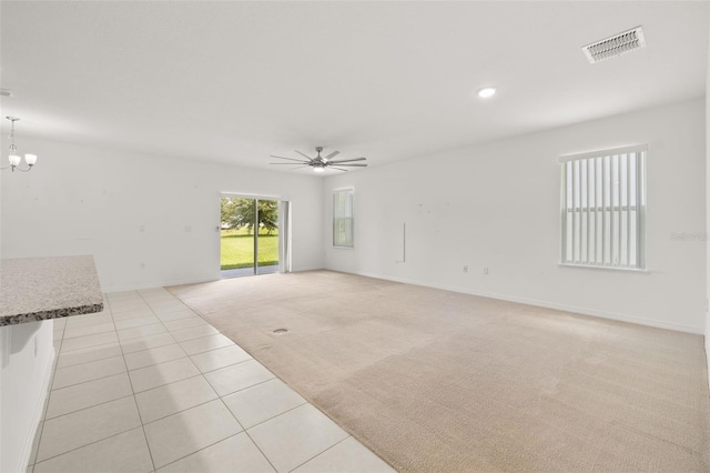 371 Pinecrest Loop, Davenport, FL 33837 - unfurnished living room featuring light tile patterned floors, light carpet, ceiling fan, a chandelier, and recessed lighting