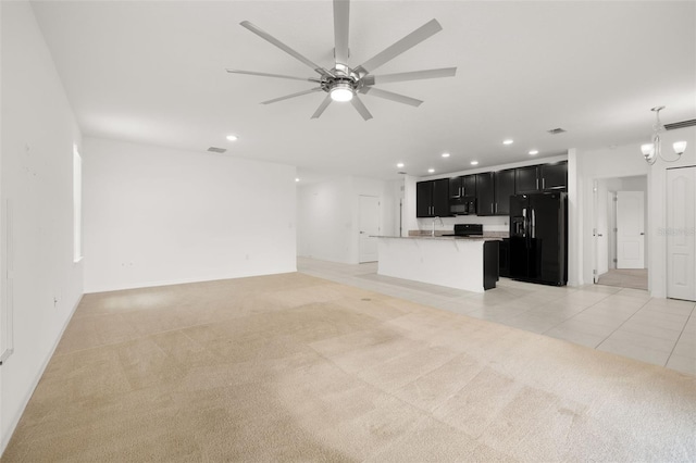 371 Pinecrest Loop, Davenport, FL 33837 - unfurnished living room with recessed lighting, light carpet, ceiling fan, a chandelier, and light tile patterned floors