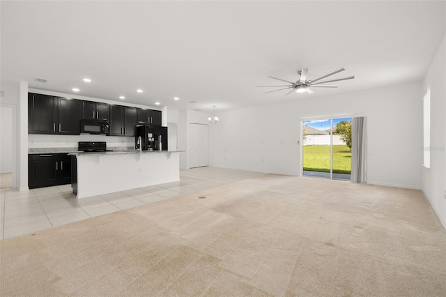 371 Pinecrest Loop, Davenport, FL 33837 - unfurnished living room with recessed lighting, ceiling fan, light tile patterned floors, a chandelier, and light carpet