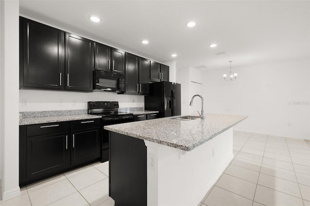 371 Pinecrest Loop, Davenport, FL 33837 - kitchen with black appliances, dark cabinetry, light tile patterned floors, a center island with sink, and recessed lighting