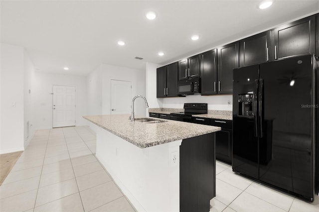371 Pinecrest Loop, Davenport, FL 33837 - kitchen with black appliances, dark cabinets, a center island with sink, light tile patterned floors, and recessed lighting