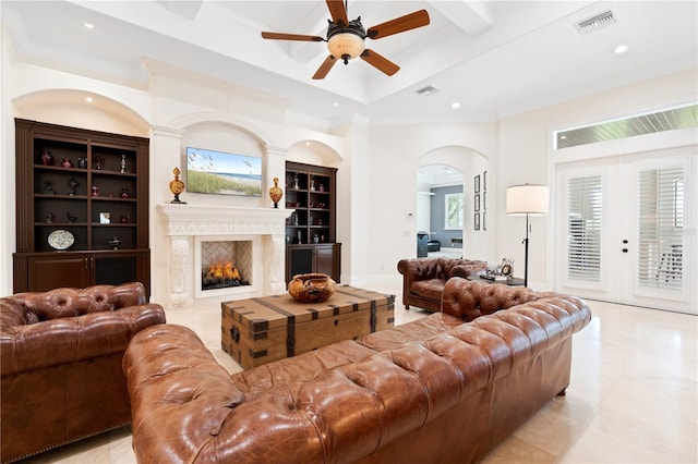 9905 Lanai View Ct, Windermere, FL 34786 - living area featuring a ceiling fan, recessed lighting, ornamental molding, arched walkways, and a lit fireplace