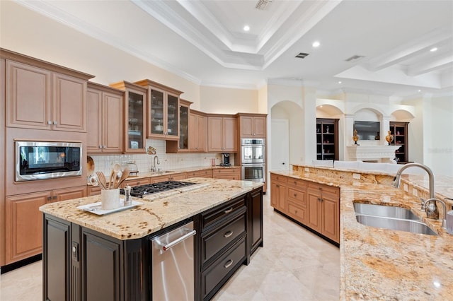 9905 Lanai View Ct, Windermere, FL 34786 - kitchen featuring a raised ceiling, stainless steel appliances, light stone countertops, tasteful backsplash, and glass insert cabinets