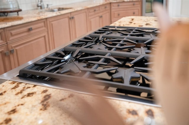 9905 Lanai View Ct, Windermere, FL 34786 - kitchen view of tasteful backsplash, stainless steel gas stovetop, and oven