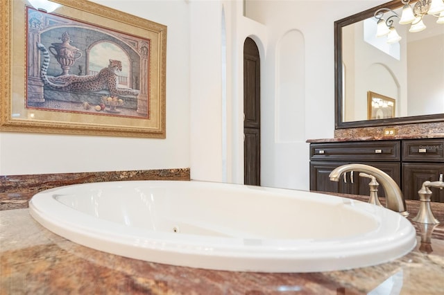 9905 Lanai View Ct, Windermere, FL 34786 - bathroom featuring vanity and a jetted tub