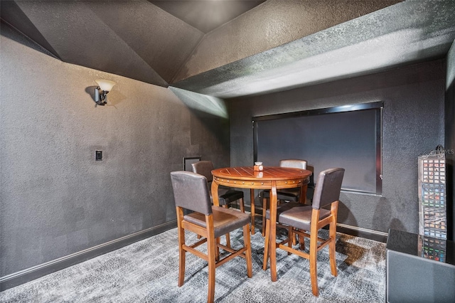 9905 Lanai View Ct, Windermere, FL 34786 - carpeted dining area with a textured wall and vaulted ceiling