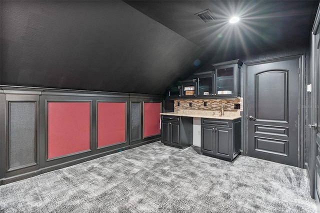 9905 Lanai View Ct, Windermere, FL 34786 - bar area featuring carpet, lofted ceiling, and backsplash