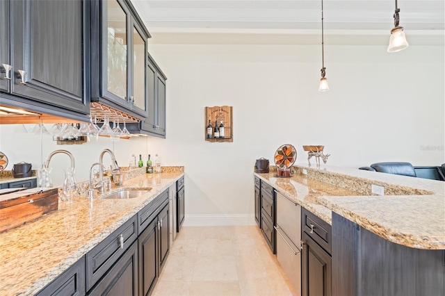 9905 Lanai View Ct, Windermere, FL 34786 - kitchen featuring a peninsula, crown molding, light stone counters, glass insert cabinets, and decorative light fixtures