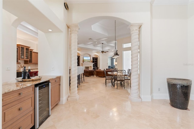9905 Lanai View Ct, Windermere, FL 34786 - indoor dry bar with wine cooler, ornate columns, ceiling fan, coffered ceiling, and arched walkways