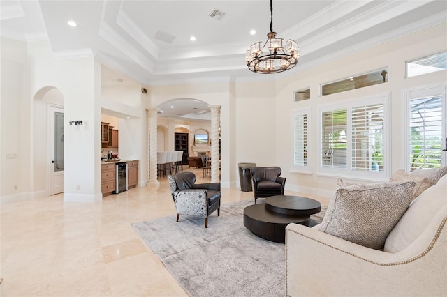 9905 Lanai View Ct, Windermere, FL 34786 - living room with ornate columns, beverage cooler, arched walkways, crown molding, and recessed lighting
