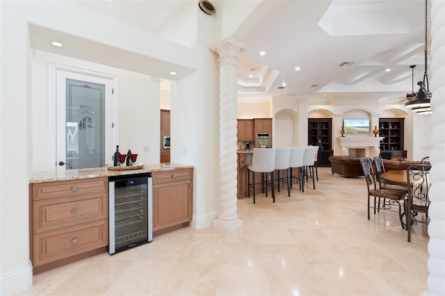 9905 Lanai View Ct, Windermere, FL 34786 - indoor bar with beverage cooler, decorative columns, recessed lighting, oven, and arched walkways