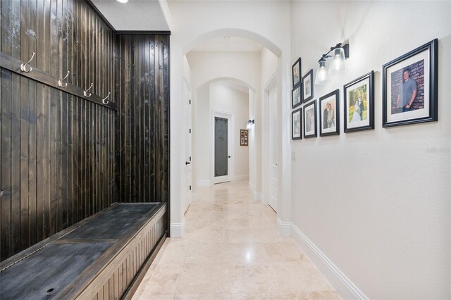 9905 Lanai View Ct, Windermere, FL 34786 - hallway featuring arched walkways and baseboards