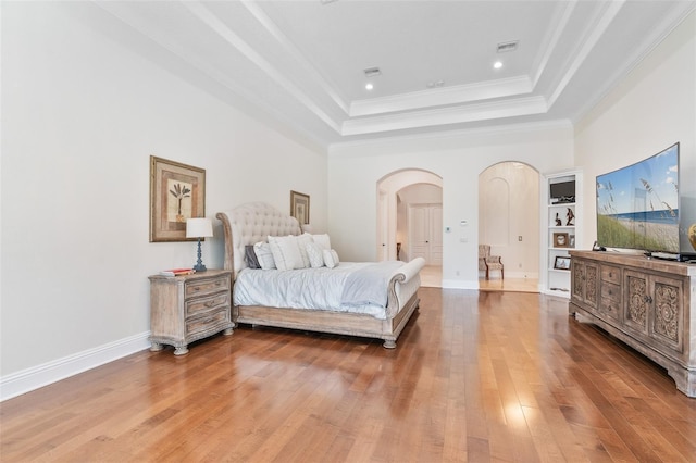 9905 Lanai View Ct, Windermere, FL 34786 - bedroom featuring arched walkways, a raised ceiling, hardwood / wood-style floors, crown molding, and recessed lighting