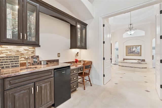 9905 Lanai View Ct, Windermere, FL 34786 - bar area with arched walkways, black dishwasher, backsplash, hanging light fixtures, and ornamental molding