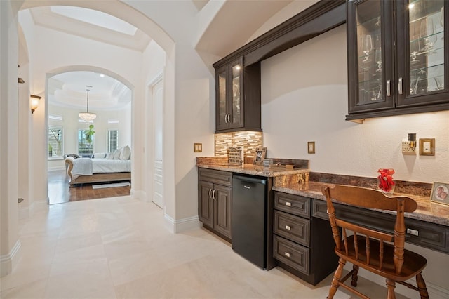 9905 Lanai View Ct, Windermere, FL 34786 - indoor bar featuring arched walkways, dishwasher, ornamental molding, and decorative backsplash