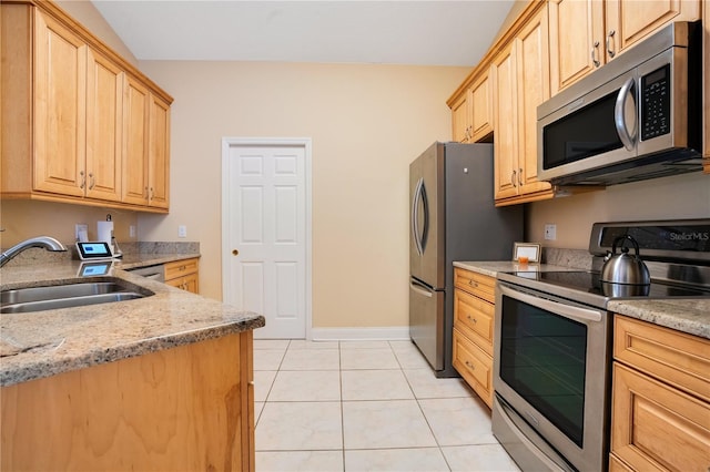 746 Stonewyk Way, Kissimmee, FL 34744 - kitchen featuring stainless steel appliances, light brown cabinetry, light tile patterned floors, and light stone countertops