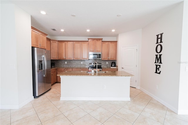 4928 Cortland Dr, Davenport, FL 33837 - kitchen with appliances with stainless steel finishes, light stone countertops, backsplash, a center island with sink, and light tile patterned floors