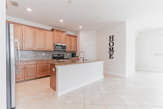 4928 Cortland Dr, Davenport, FL 33837 - kitchen featuring stainless steel appliances, stone counters, tasteful backsplash, a kitchen island with sink, and recessed lighting