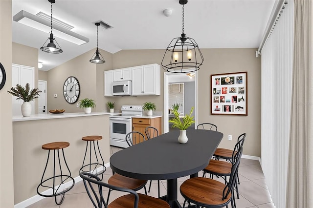 107 Whitehall Way, Kissimmee, FL 34758 - kitchen featuring white appliances, lofted ceiling, light tile patterned floors, light countertops, and white cabinets