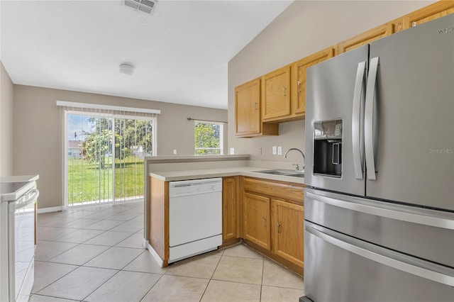107 Whitehall Way, Kissimmee, FL 34758 - kitchen with white appliances, light tile patterned floors, a peninsula, and light countertops