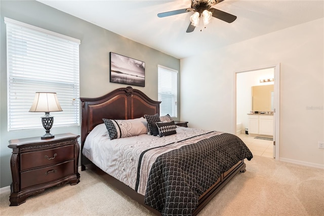5231 Wildwood Way, Davenport, FL 33837 - bedroom featuring light colored carpet, ensuite bathroom, and ceiling fan