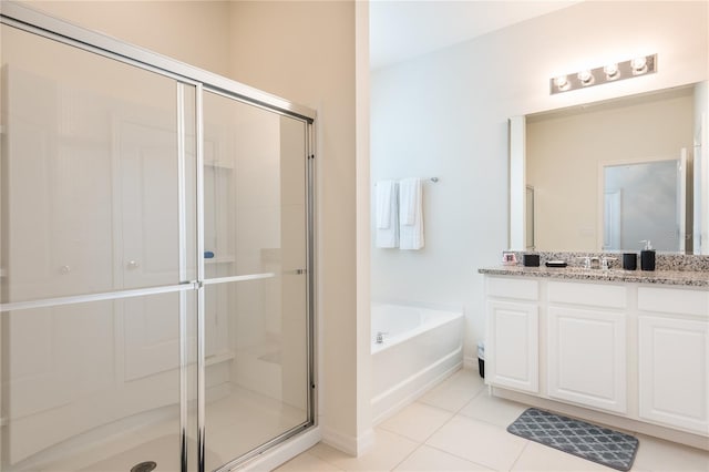 5231 Wildwood Way, Davenport, FL 33837 - full bath featuring vanity, a stall shower, a garden tub, and tile patterned flooring