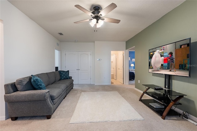 5231 Wildwood Way, Davenport, FL 33837 - carpeted living room with ceiling fan and baseboards