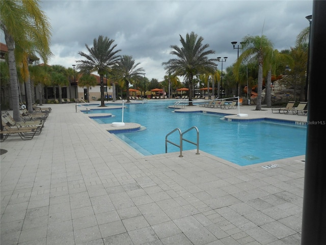 5231 Wildwood Way, Davenport, FL 33837 - community pool featuring a patio area