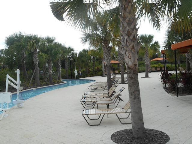 5231 Wildwood Way, Davenport, FL 33837 - community pool featuring a patio area