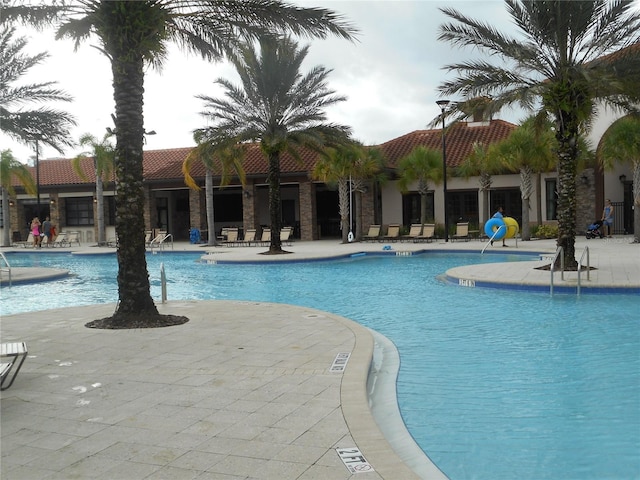 5231 Wildwood Way, Davenport, FL 33837 - community pool with a patio