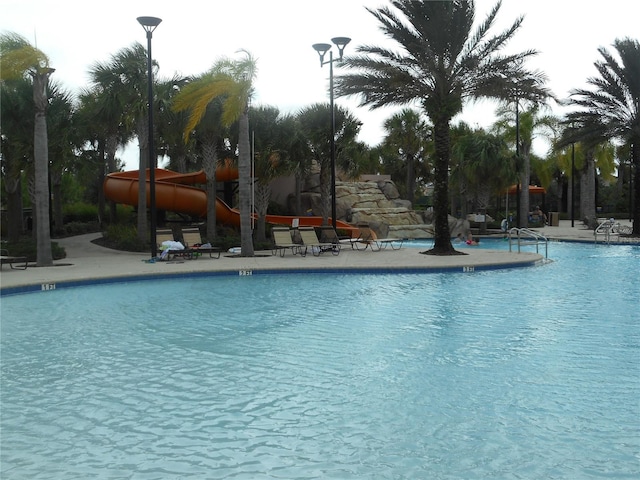 5231 Wildwood Way, Davenport, FL 33837 - community pool with a patio area