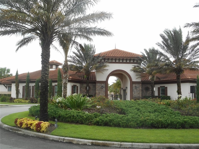 5231 Wildwood Way, Davenport, FL 33837 - view of front of home featuring stucco siding, a tiled roof, and stone siding