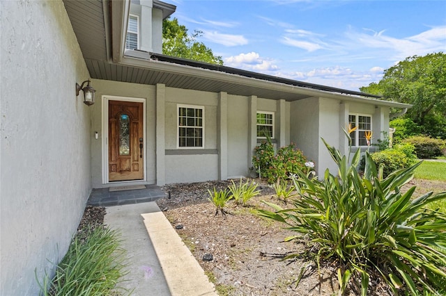 878 Elgin Dr, Winter Springs, FL 32708 - view of exterior entry featuring stucco siding and covered porch