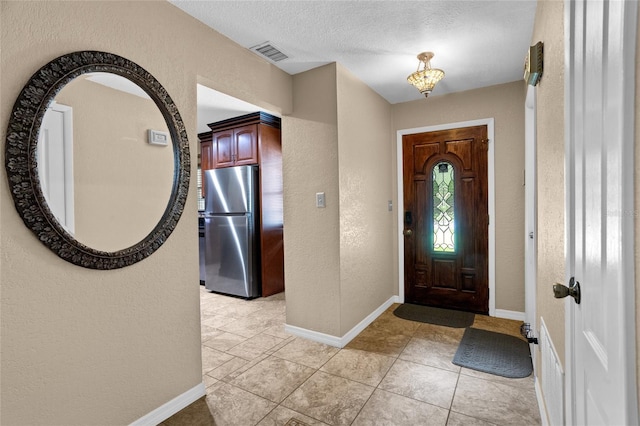 878 Elgin Dr, Winter Springs, FL 32708 - foyer featuring a textured wall, light tile patterned floors, and a textured ceiling