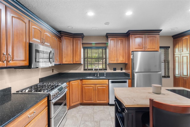 878 Elgin Dr, Winter Springs, FL 32708 - kitchen with appliances with stainless steel finishes, recessed lighting, a textured ceiling, brown cabinetry, and dark stone countertops