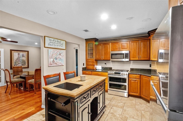 878 Elgin Dr, Winter Springs, FL 32708 - kitchen featuring stainless steel appliances, wooden counters, brown cabinetry, recessed lighting, and ceiling fan