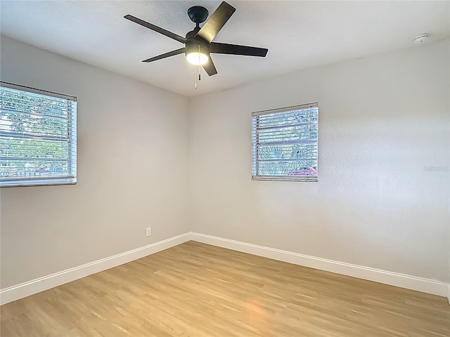 4202 W Bay Vista Ave, Tampa, FL 33611 - empty room with a smoke detector, light wood-type flooring, and a ceiling fan