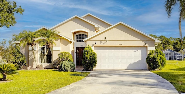 1014 Prey Ct, Kissimmee, FL 34746 - view of front of home with an attached garage, stucco siding, concrete driveway, and a front yard