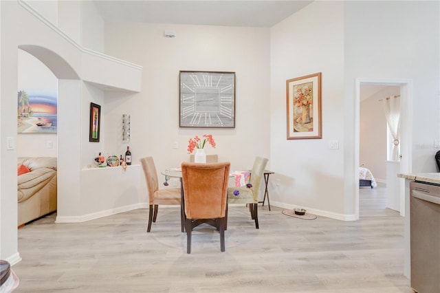 1014 Prey Ct, Kissimmee, FL 34746 - dining room featuring light wood-type flooring and arched walkways