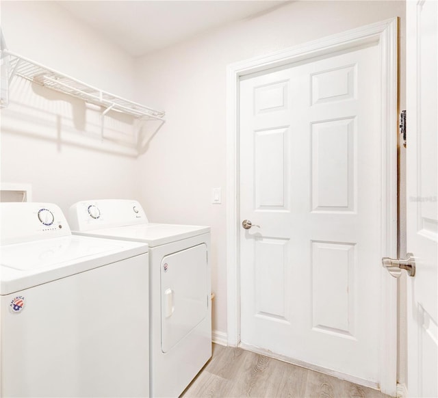 1014 Prey Ct, Kissimmee, FL 34746 - laundry area with washing machine and clothes dryer and light wood-type flooring