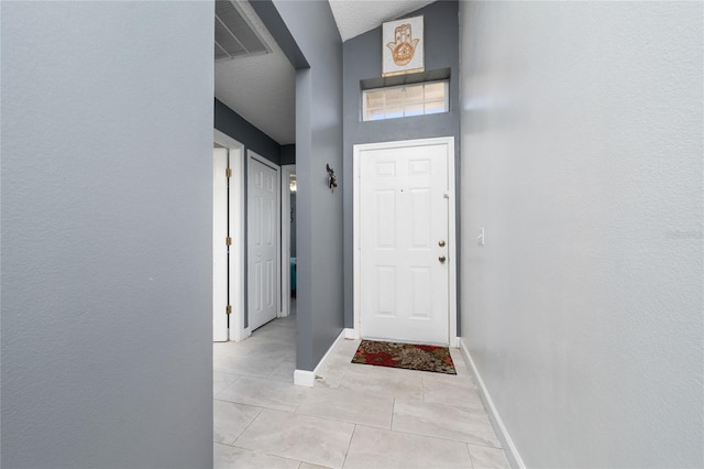 5100 Violet Ln, Kissimmee, FL 34758 - doorway to outside featuring light tile patterned flooring and baseboards