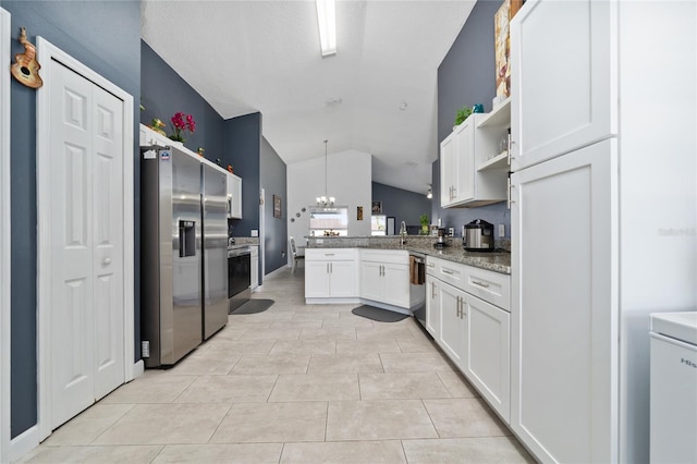 5100 Violet Ln, Kissimmee, FL 34758 - kitchen featuring appliances with stainless steel finishes, a peninsula, lofted ceiling, open shelves, and white cabinets
