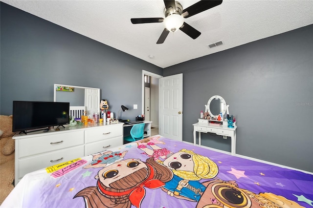 5100 Violet Ln, Kissimmee, FL 34758 - carpeted bedroom with ceiling fan and a textured ceiling