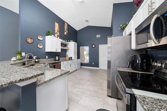 5100 Violet Ln, Kissimmee, FL 34758 - kitchen with stainless steel appliances, high vaulted ceiling, light stone countertops, white cabinetry, and open shelves