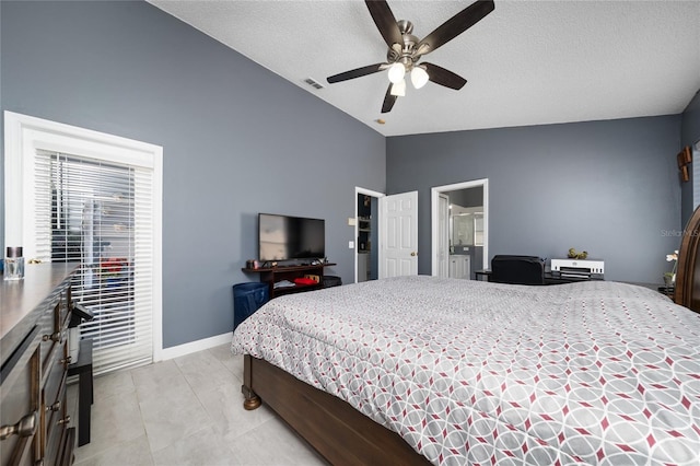 5100 Violet Ln, Kissimmee, FL 34758 - bedroom with lofted ceiling, a textured ceiling, a ceiling fan, connected bathroom, and light tile patterned floors
