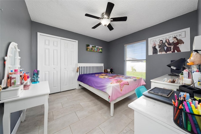 5100 Violet Ln, Kissimmee, FL 34758 - bedroom featuring a textured ceiling, a closet, ceiling fan, and light tile patterned floors
