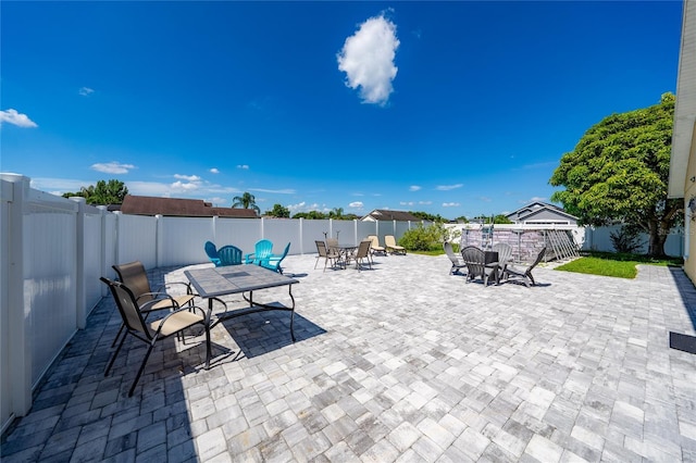 5100 Violet Ln, Kissimmee, FL 34758 - fenced backyard with outdoor dining space and a patio