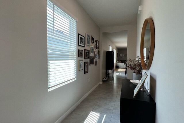 2727 Harmonia Hammock Rd, Harmony, FL 34773 - hallway featuring light tile patterned floors and plenty of natural light