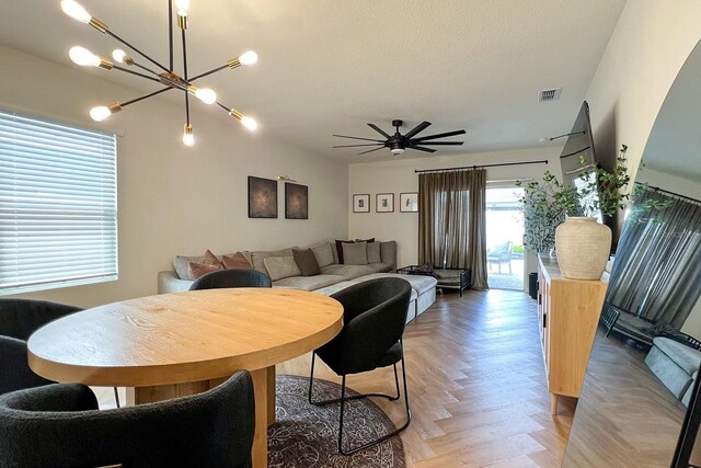 2727 Harmonia Hammock Rd, Harmony, FL 34773 - dining area with a chandelier and a ceiling fan