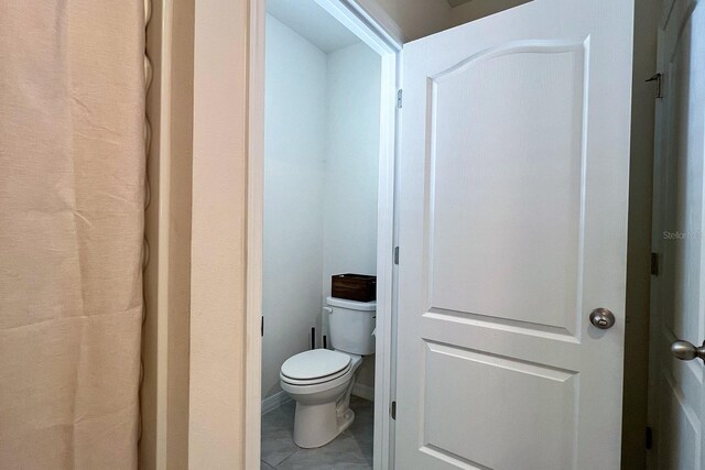 2727 Harmonia Hammock Rd, Harmony, FL 34773 - bathroom with toilet and tile patterned floors